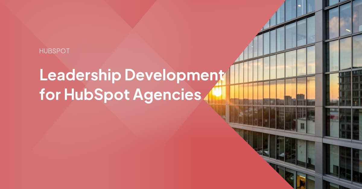 A senior HubSpot consultant reviewing a client portal build alongside two junior team members, illustrating mentorship-based leadership development at an agency
