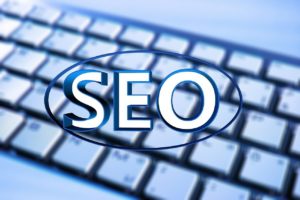 SEO concept image with the acronym SEO on top of a keyboard