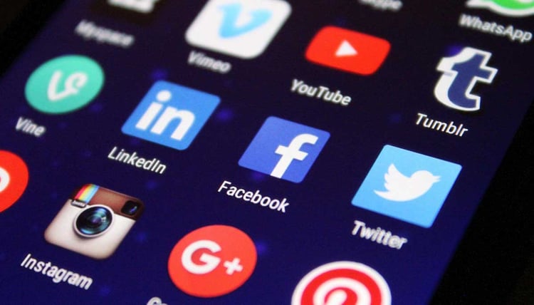 Image is of the home screen of a phone with several different social media app icons including LinkedIn, Facebook, Twitter, and Instagram.
