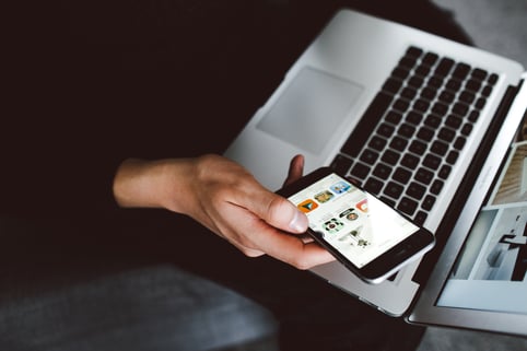 Negative buyer personas person on laptop looking at phone